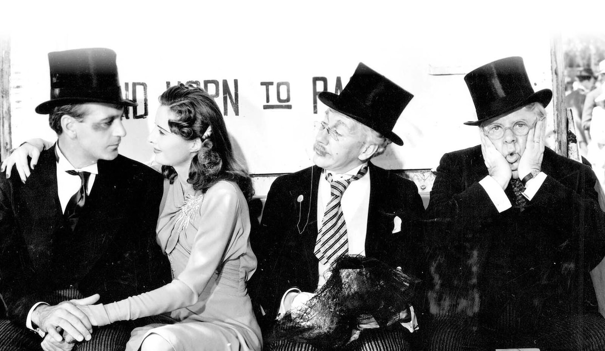 Four people from a classic film, one looking confused